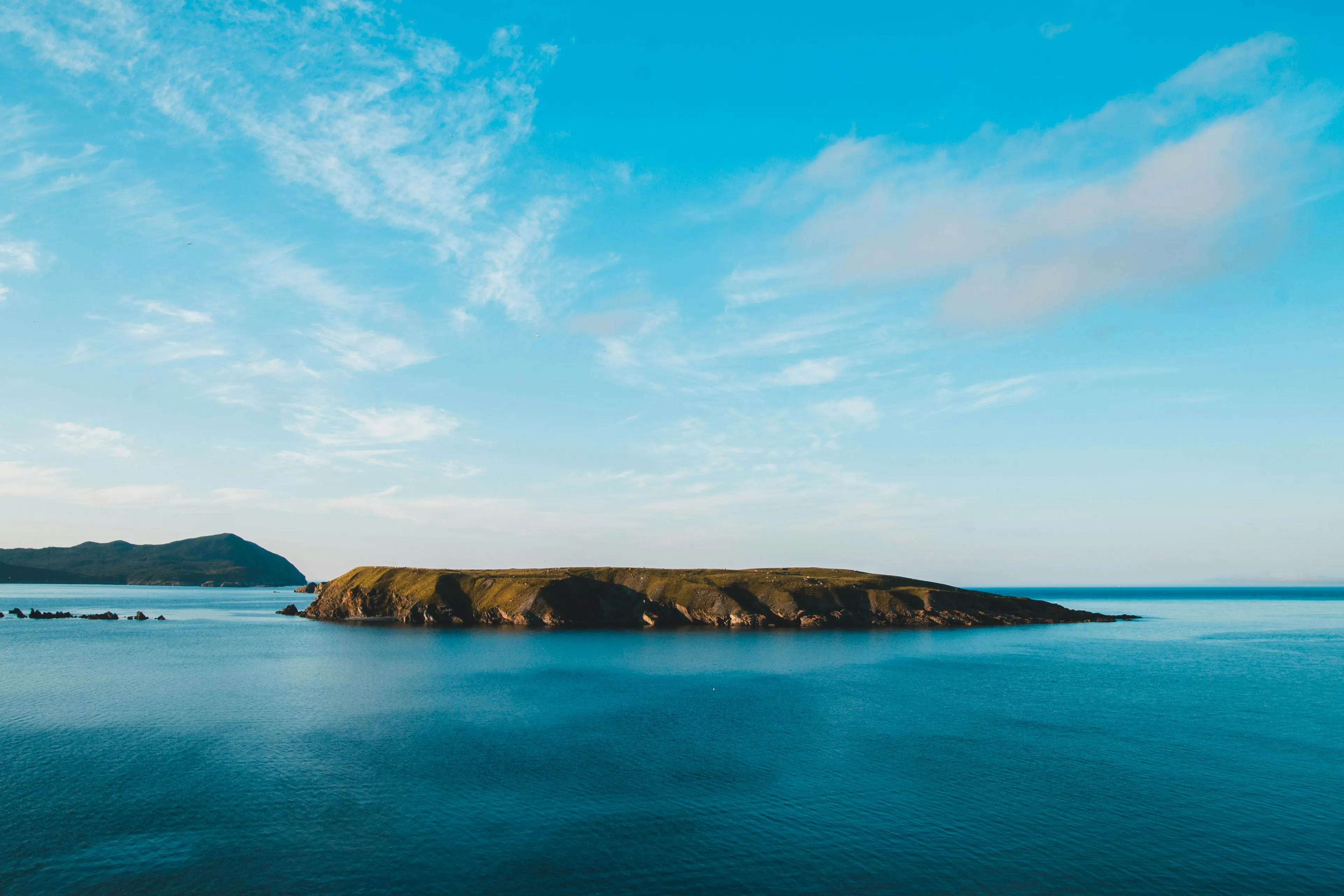 A remote island surrounded by calm blue waters under a bright sky in an easy-to-hard general knowledge quiz concept.
