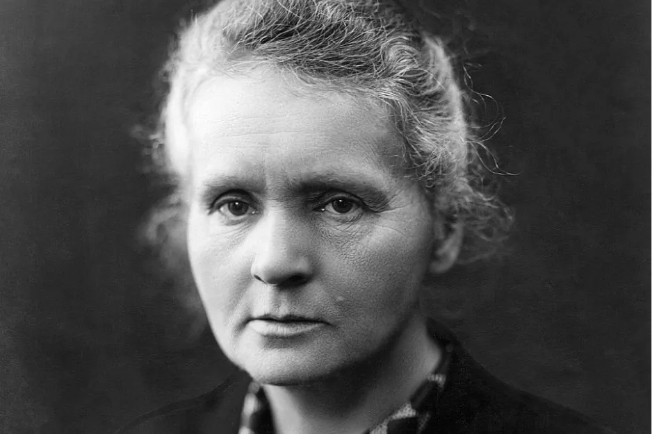 Marie Curie portrait in black and white, showing the first woman to win a Nobel Prize with a serious expression.