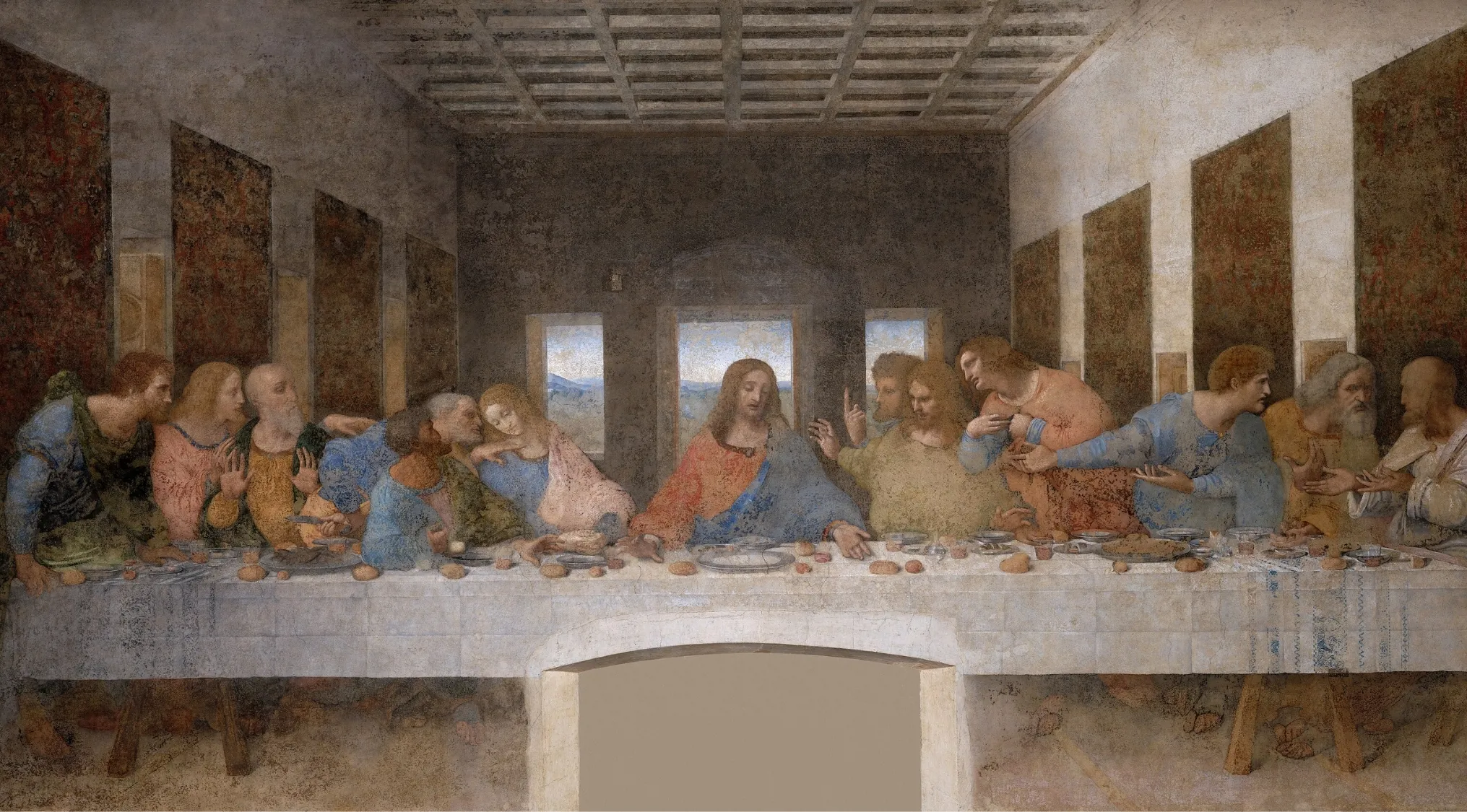 The Last Supper painting by Leonardo da Vinci showing Jesus and his disciples at a long table in a historic room.