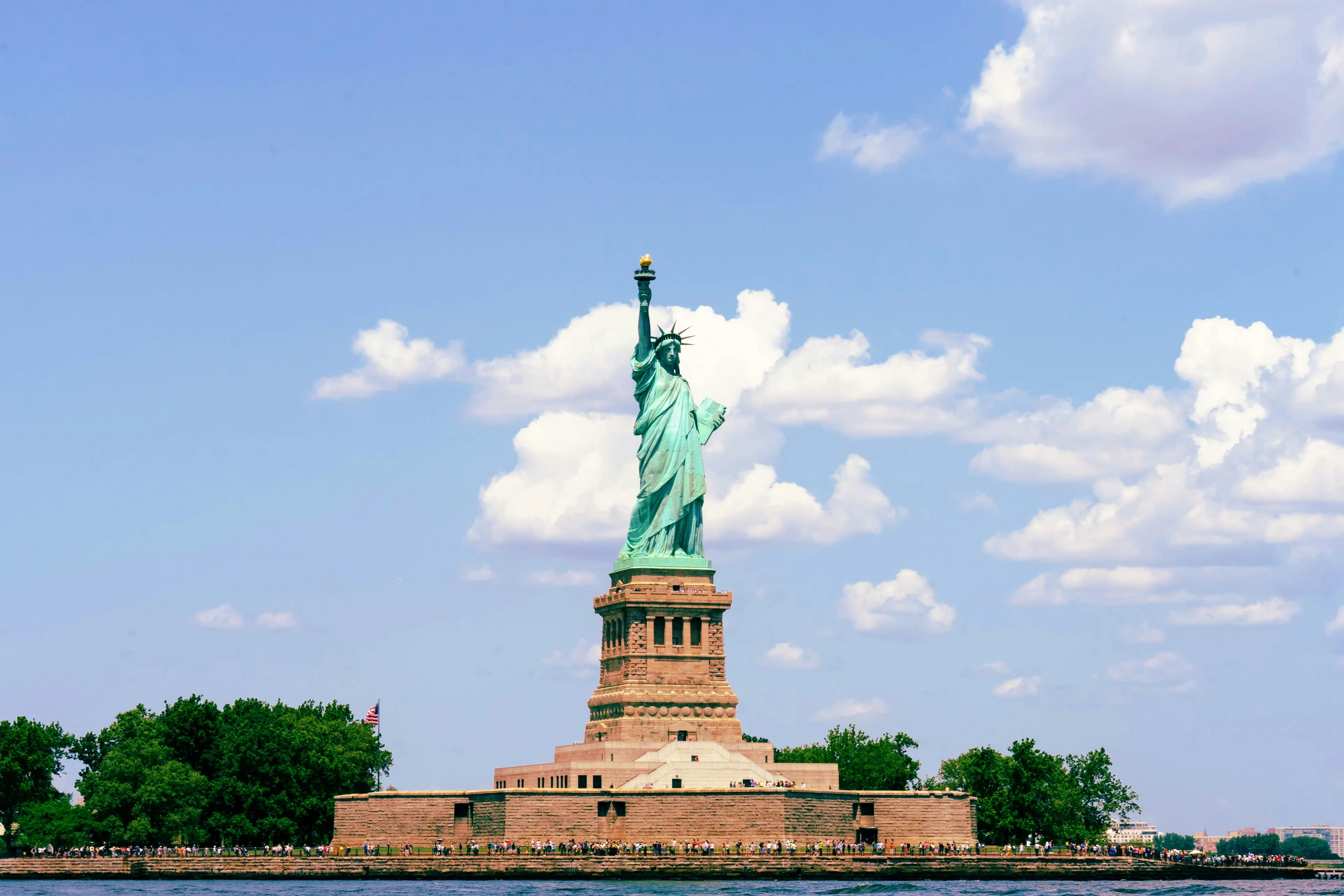 Statue of Liberty standing tall with a blue sky, highlighting its original color before it turned green.