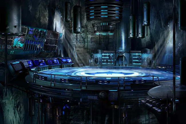 High-tech Batcave TV setting with futuristic control panels and glowing blue lights in an underground cave environment.