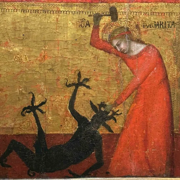 Medieval art depicting a saint in red slaying a bizarre black creature with clawed limbs and a spiked tail.