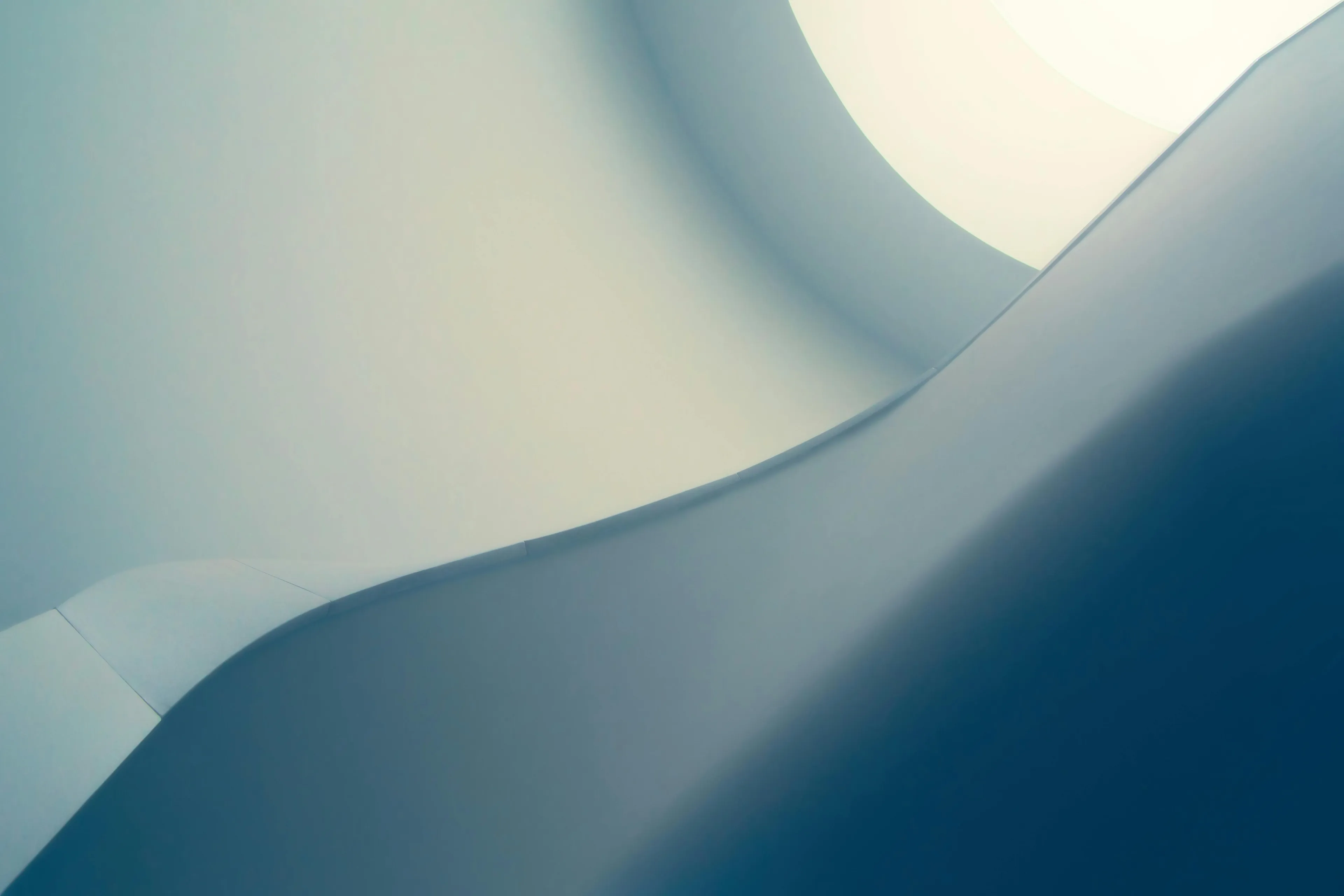 Abstract and colorful phone wallpaper featuring smooth curved shapes in shades of blue, white, and light gray with soft lighting.