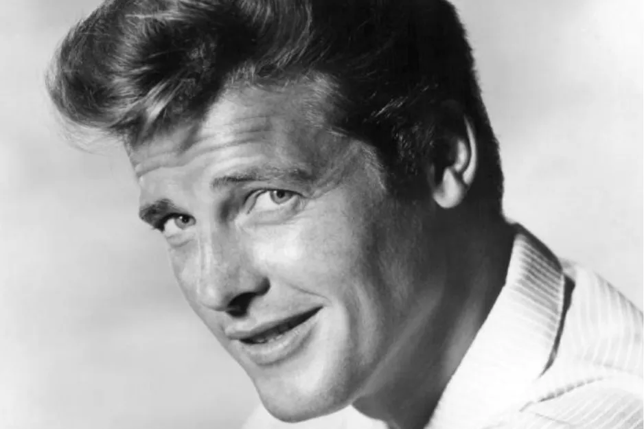 Black and white close-up portrait of a smiling man with styled hair, related to James Bond actors and Roger Moore.