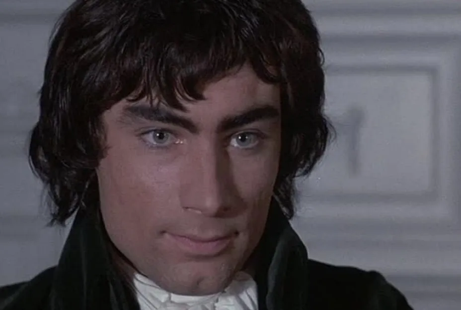 Close-up of a man with dark hair and blue eyes in period costume related to James Bond actors Timothy Dalton question.