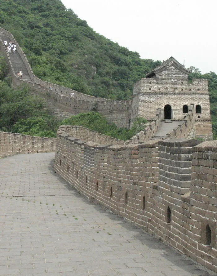 Great Wall of China winding through green hills, illustrating well-known facts that are actually fake misconceptions.
