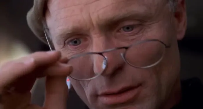 In The Truman Show, the producer Christof created a live 24/7 reality TV show in which Truman lives in a fake world from birth, without knowing it. Christof did it to capitalize on viewers’ need for real, unscripted emotion, and argues that a safe, comfortable world is better for Truman than the dangers of the modern, chaotic world.