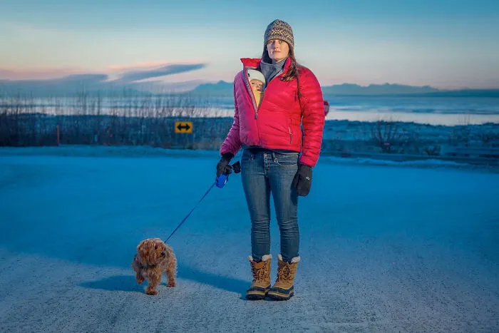 Kaitlyn Reiley Walks With Her Seven Month Old Daughter, Beatrice, And Her Dog, Jack, Near Her Home On A Cold January Day In Anchorage, Alaska, 2015 From The Series 'Portrait-A-Day' By Clark James Mishler
