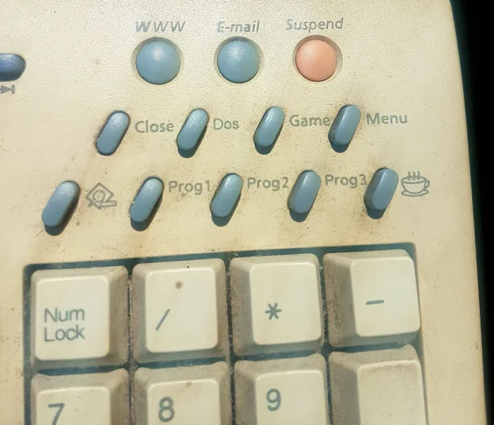 Close-up of a vintage keyboard with unique buttons labeled for internet functions and unidentified objects mystery solved.
