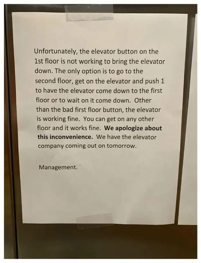 Printed note explaining the elevator button on the first floor is broken and instructions on how to use the elevator workaround.
