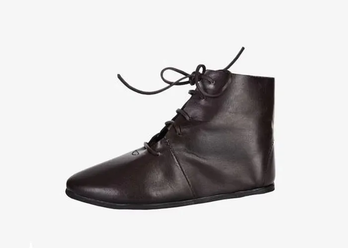 Dark brown leather shoe with laces against a white background, symbolizing first dates so horrible they build character trauma.