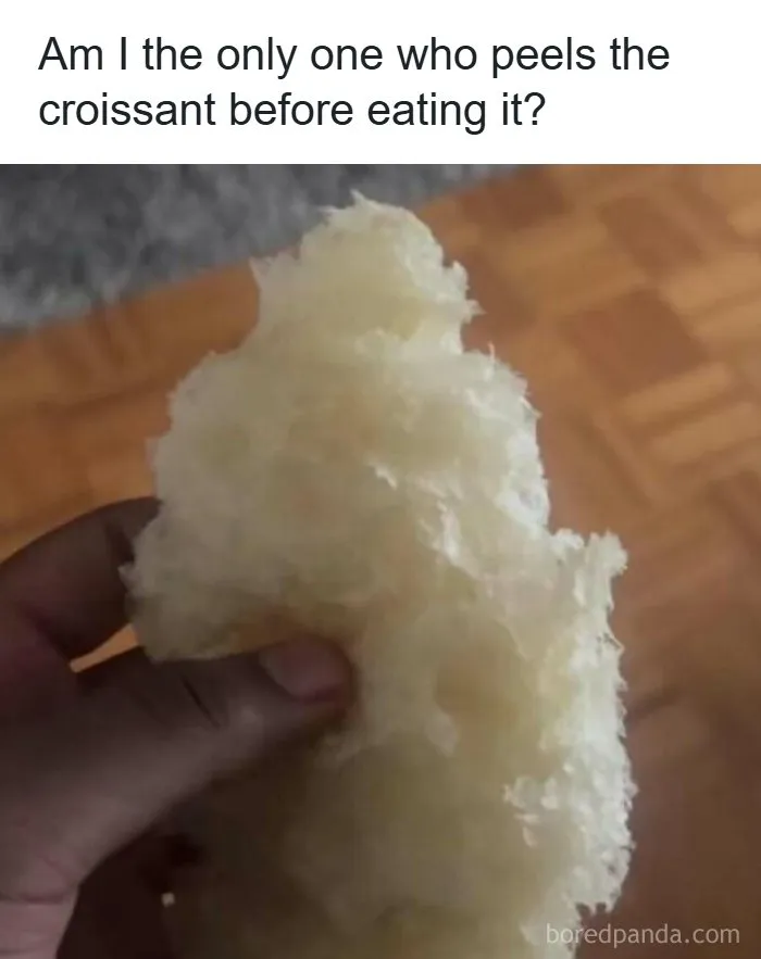 Hand holding peeled croissant layers, illustrating a food lover meme about unique eating habits.