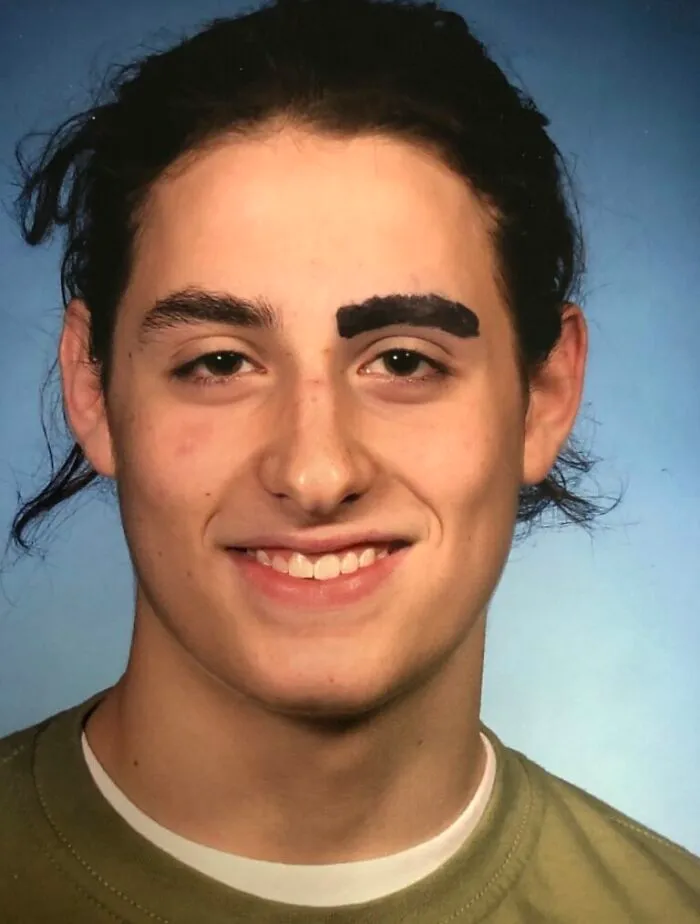 My Son’s Senior Picture, Before Which, He Inexplicably Shaved Off One Eyebrow. Apparently, The Photographer Insisted He Draw It Back On For The Photo