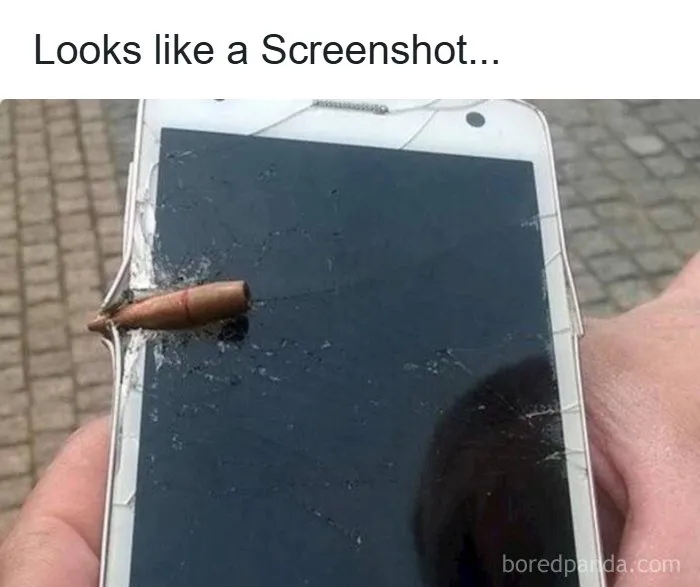 Smartphone with cracked screen pierced by a bullet, illustrating memes for those who need memes to function properly.