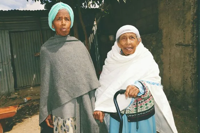 Two elderly women wrapped in shawls, representing proven facts that once were simply stories and speculations.