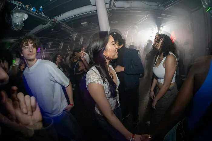 Women confidently addressing and shutting down men’s creepy advances in a crowded party setting.