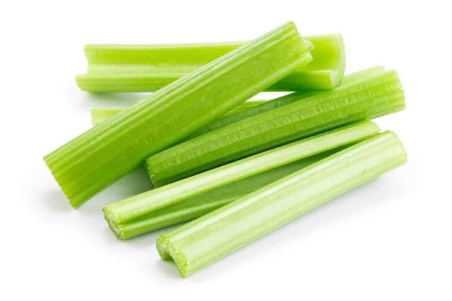 Fresh green celery sticks arranged on a white background, perfect for a healthy nervous snack choice.