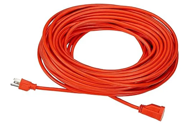 Bright orange extension cord coiled neatly, ready for use in home improvement projects and outdoor tasks.