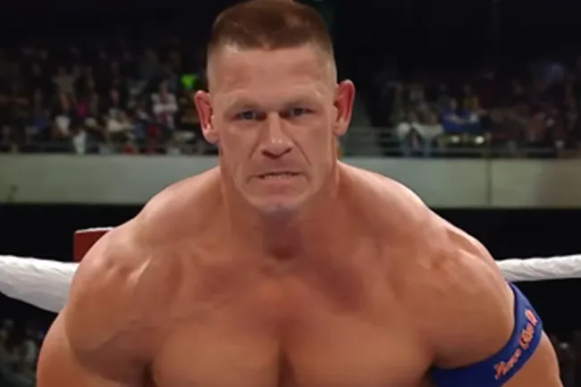 Wrestler focused in the ring, showcasing strength and determination amid a crowded arena, related to invisibility superpower concept.