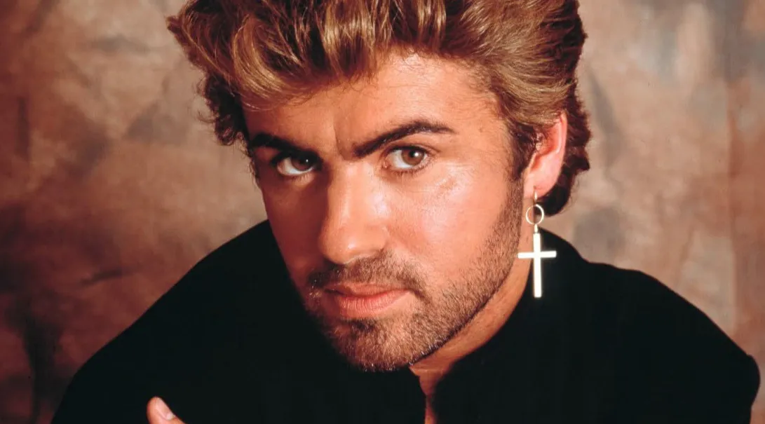 Close-up portrait of an '80s music icon wearing a black shirt and a cross earring, with styled hair and intense expression.