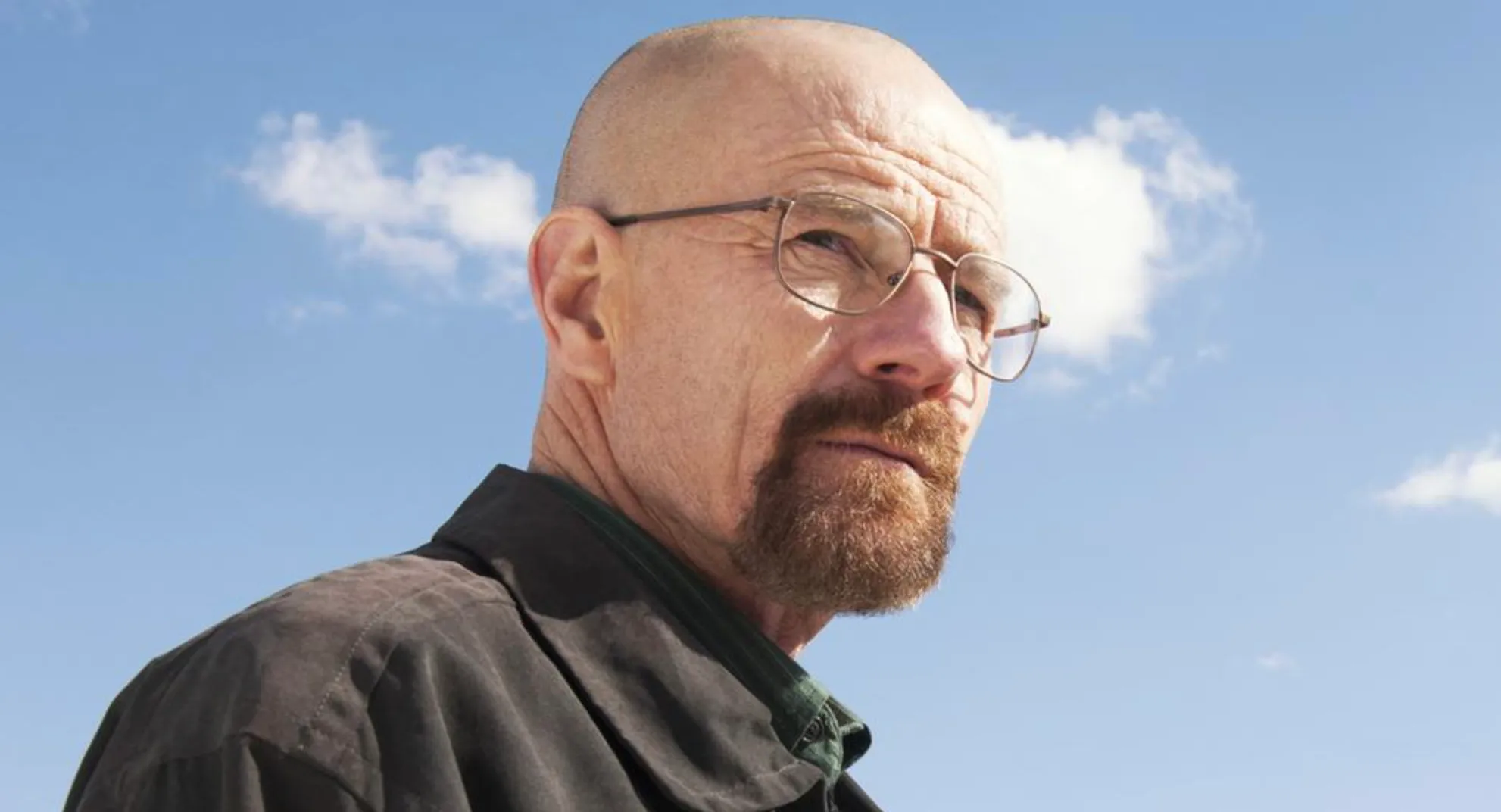 Character Walter White from Breaking Bad wearing glasses and a jacket, looking serious against a blue sky background.