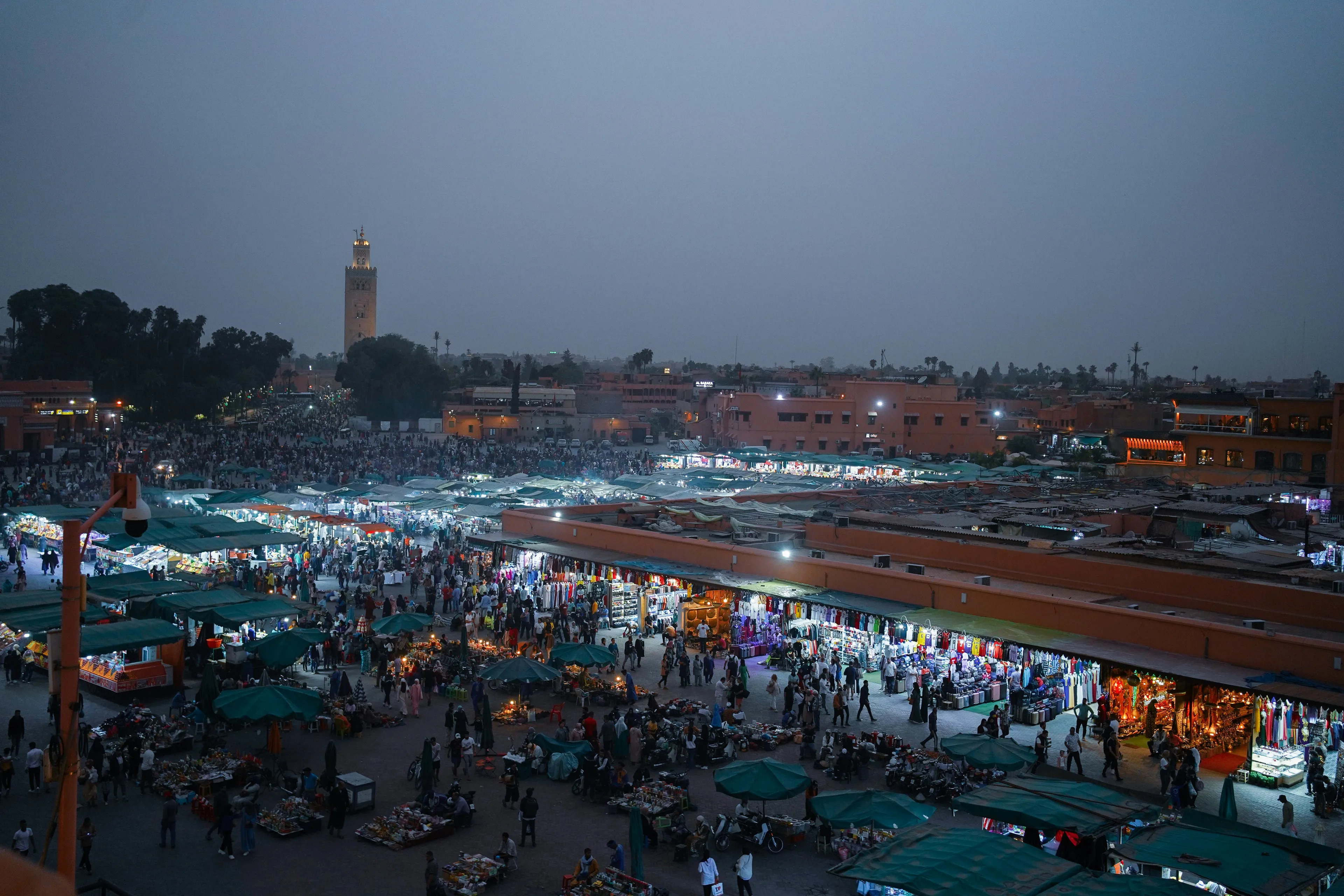 Evening view of Marrakech market bustling with people in the city of Marrakech, Morocco, during twilight hours.