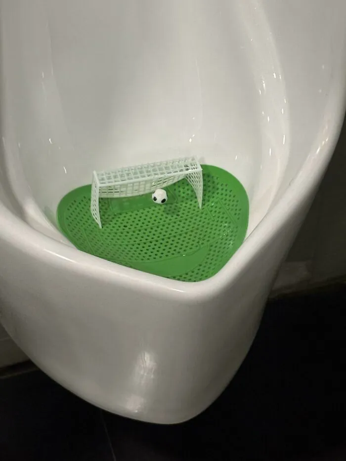 This Airport Urinal Has Soccer Nets With Balls You Can Aim At