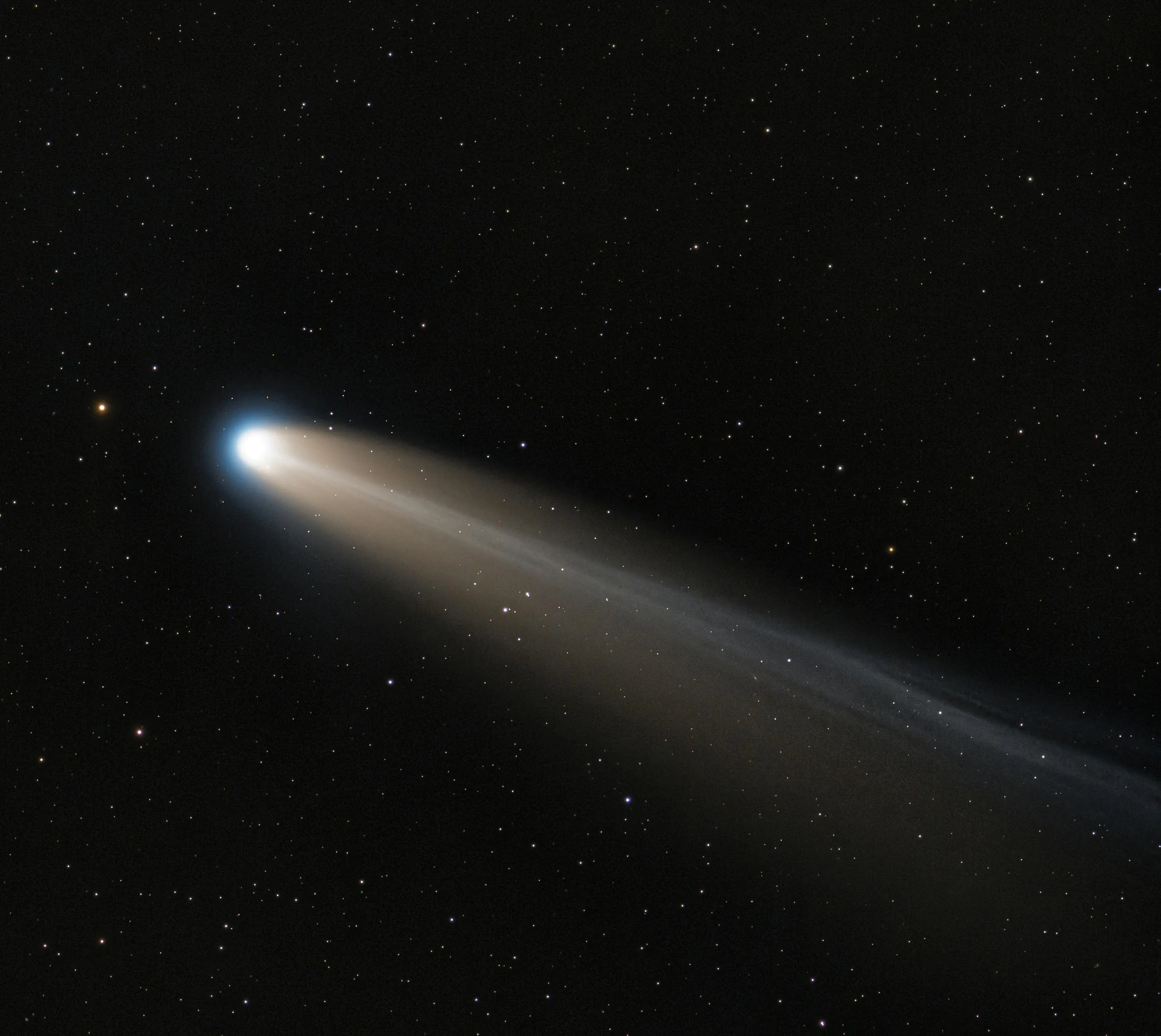 A comet composed of frozen gases, rock, and dust with a glowing tail orbiting the Sun in a starry sky.