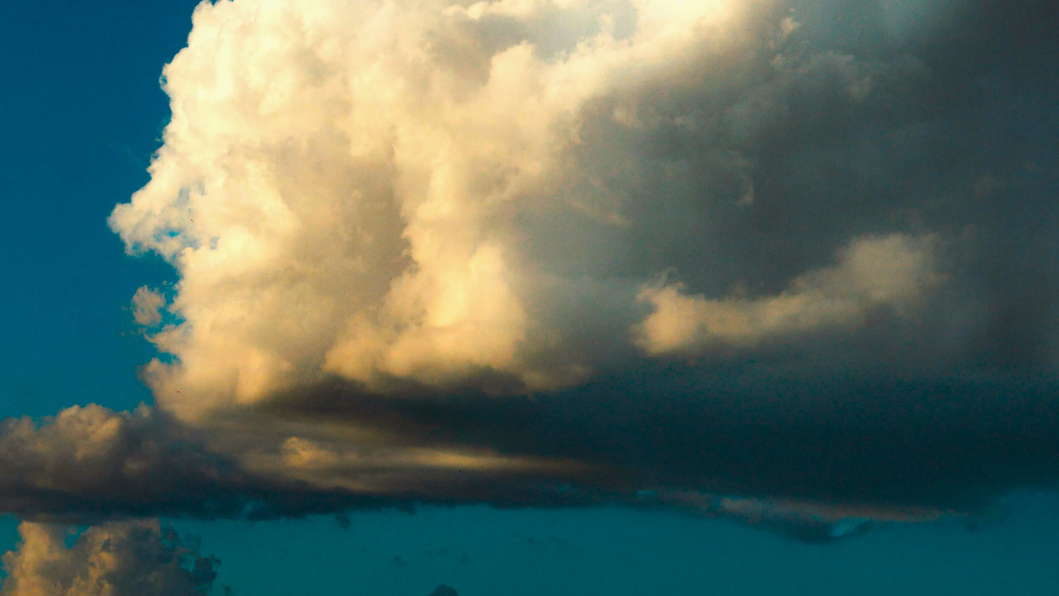 Large cumulus clouds forming in the blue sky representing air pressure for science type-in trivia instrument.