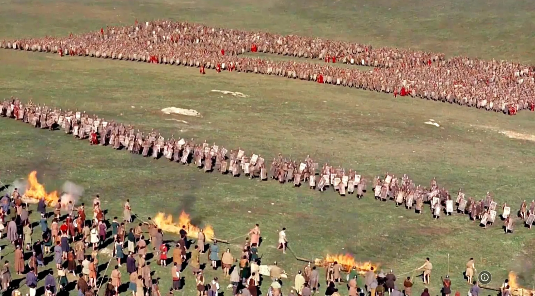 Large groups of soldiers in formation on a field during an iconic 60s movie scene battle moment.