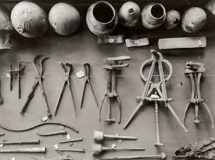 Ancient surgical and medical tools displayed as historical finds.
