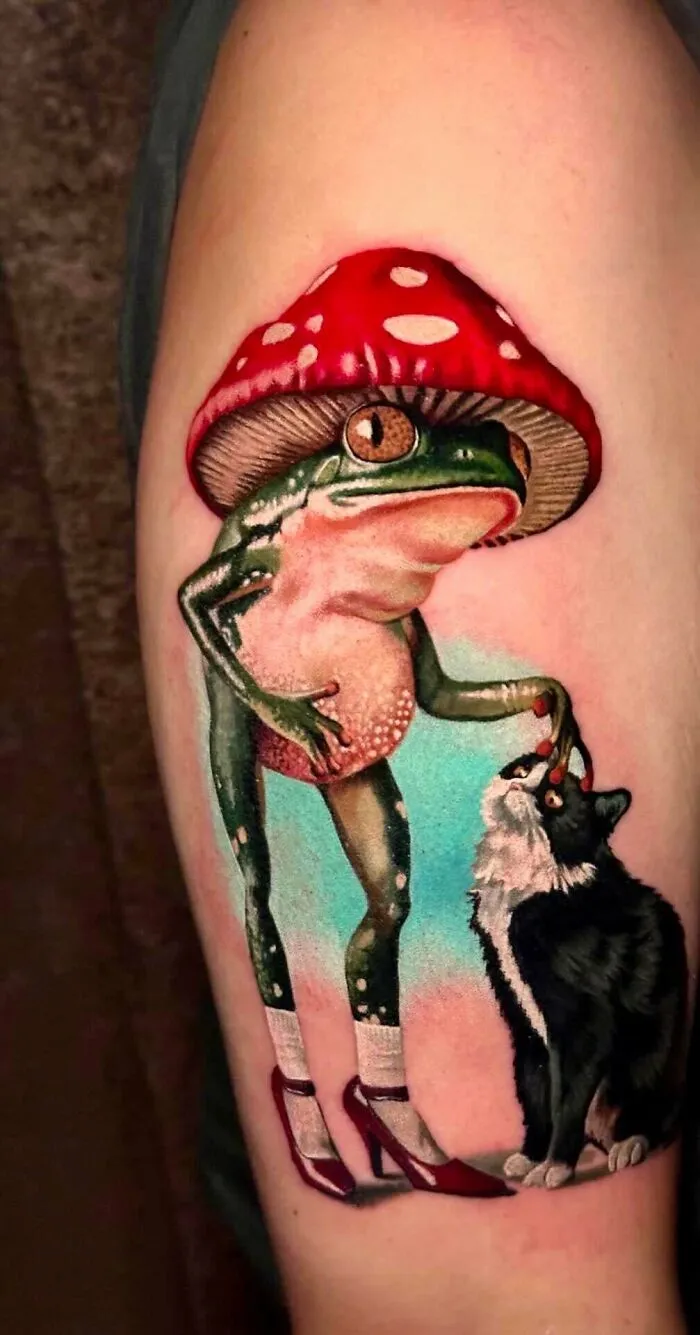 A colorful tattoo of a frog wearing a mushroom hat and high heels, feeding a black and white cat, a unique tattoo.