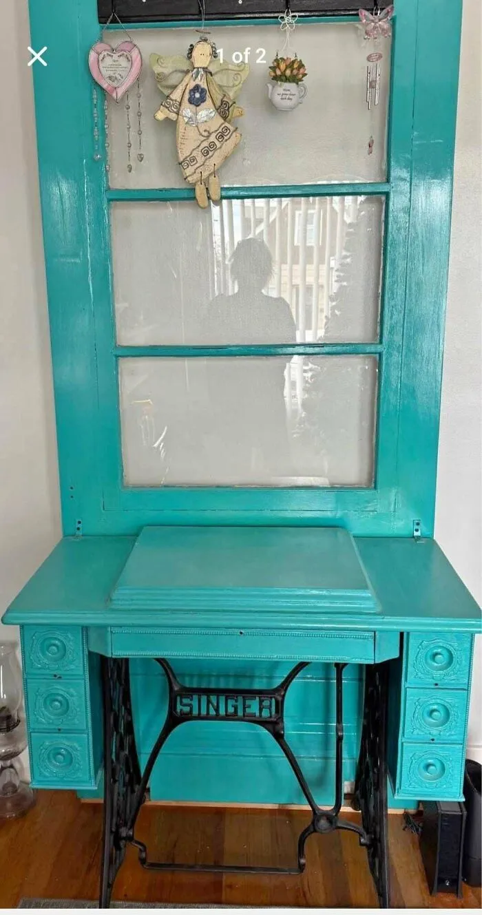 A bright turquoise repainted vintage Singer sewing machine table as a questionable DIY project.