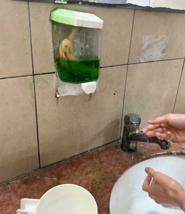 A banana in a soap dispenser above a sink, a peculiar image from the not interesting community.