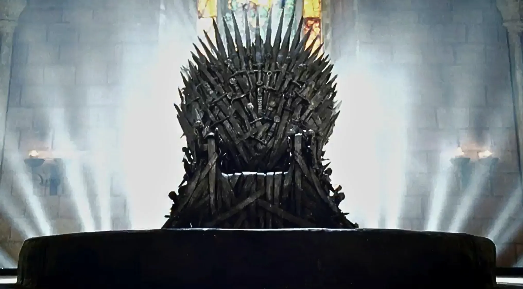 Replica made from the same mold as the on-screen iron throne displayed with dramatic lighting at an auction in 2024