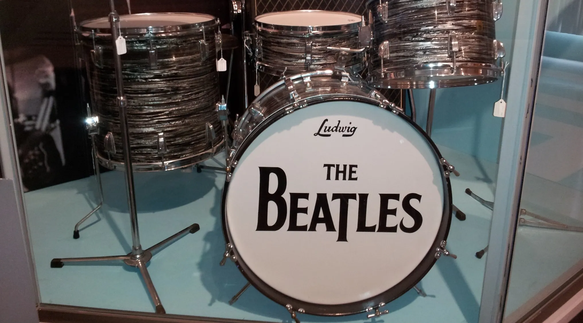 Vintage Beatles drumhead on Sir Ringo's second Ludwig drum kit displayed in a museum setting.
