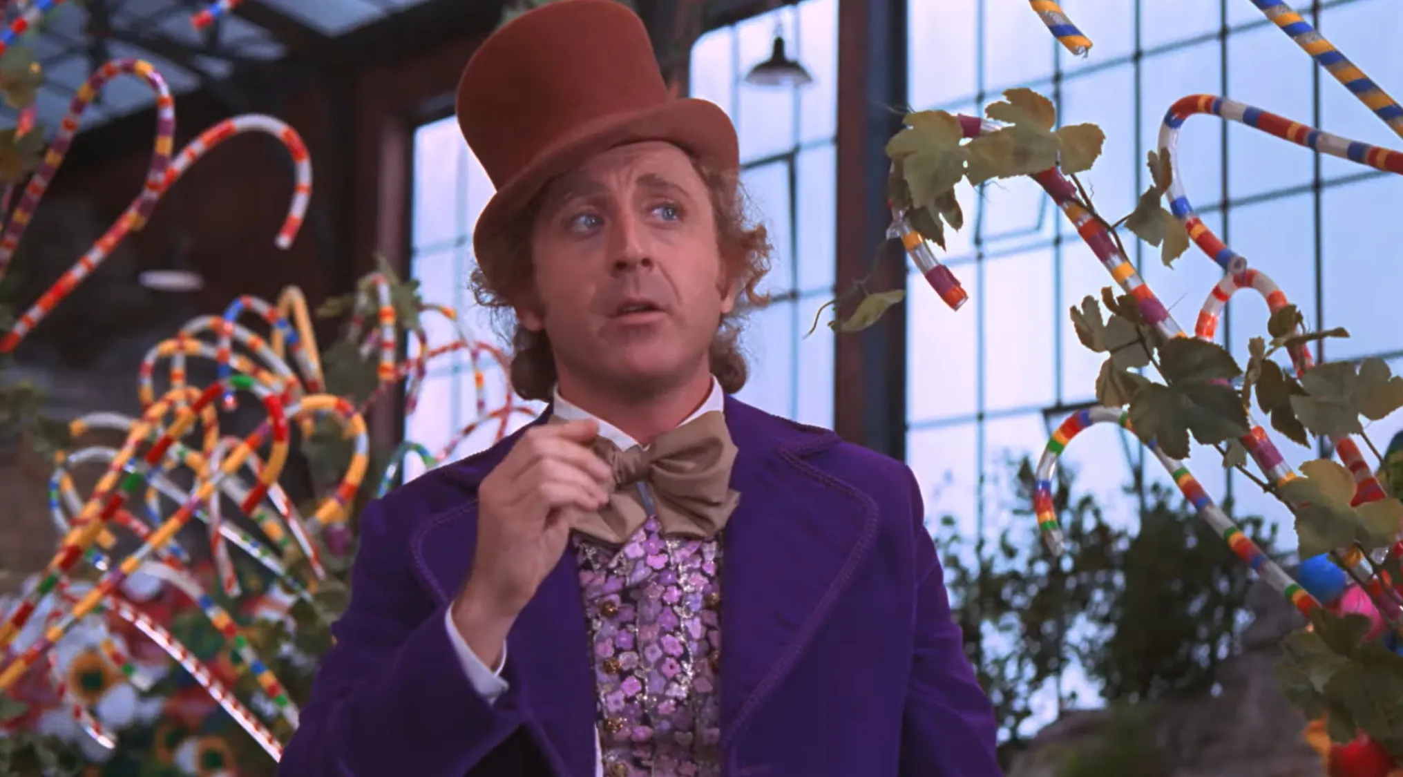 Gene Wilder as Wonka in colorful outfit with bow tie and top hat, related to price of sold items auction.