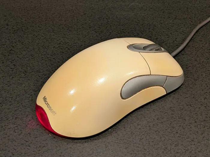 Classic wired Microsoft optical computer mouse representing old products that still work after decades of daily use.