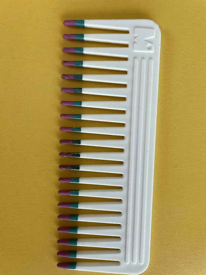 Classic white plastic comb on a yellow surface, highlighting old products that stand the test of time.