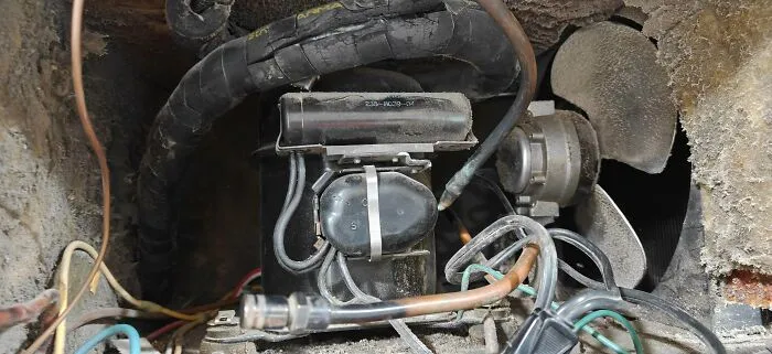 Internal mechanism and compressor of an old refrigerator, one of many durable old products.