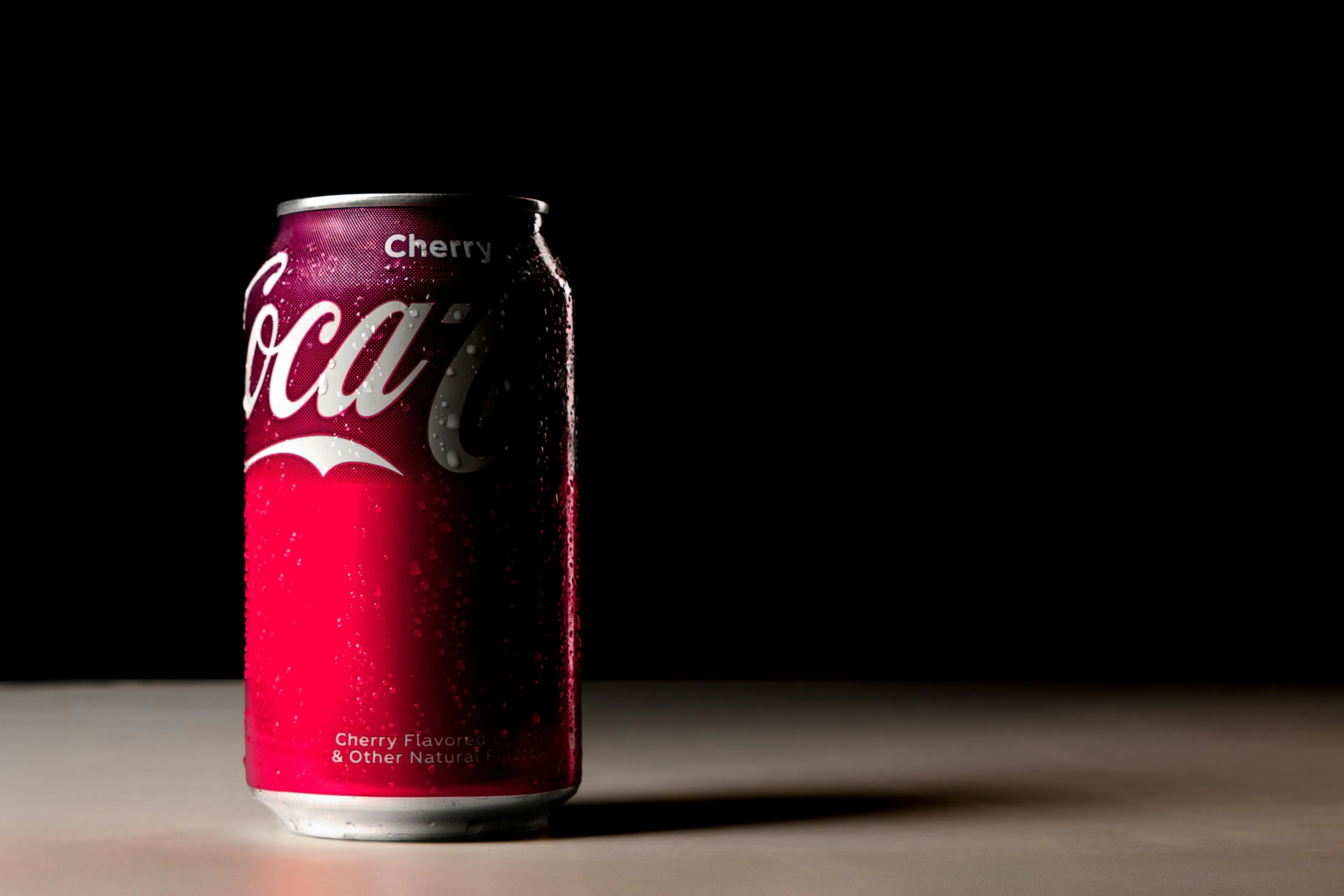 Cherry cola fizz can soda can with condensation on dark background evoking nostalgic memories.