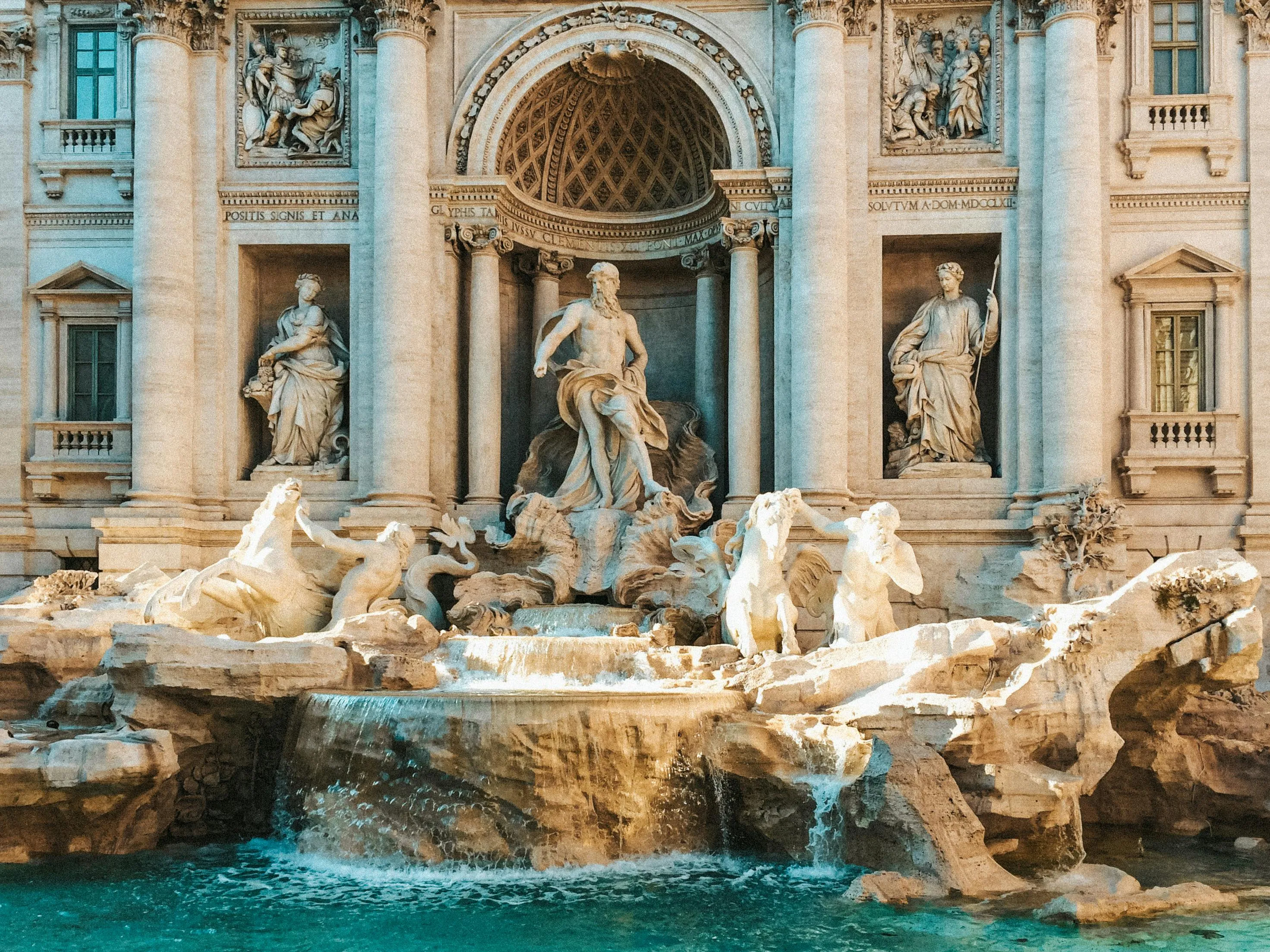 The Trevi Fountain in Rome featuring detailed sculptures and flowing water in a historic landmark setting.