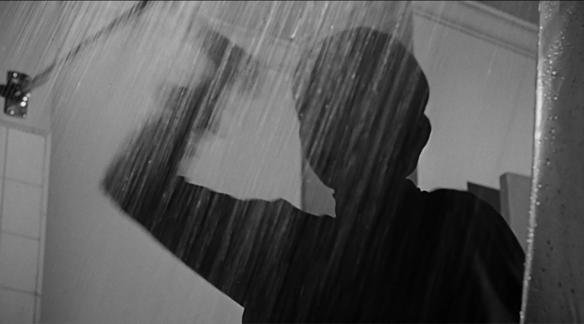 Black and white silhouette of a man in a shower, referencing the 1960 film famous for its suspenseful shower scene.