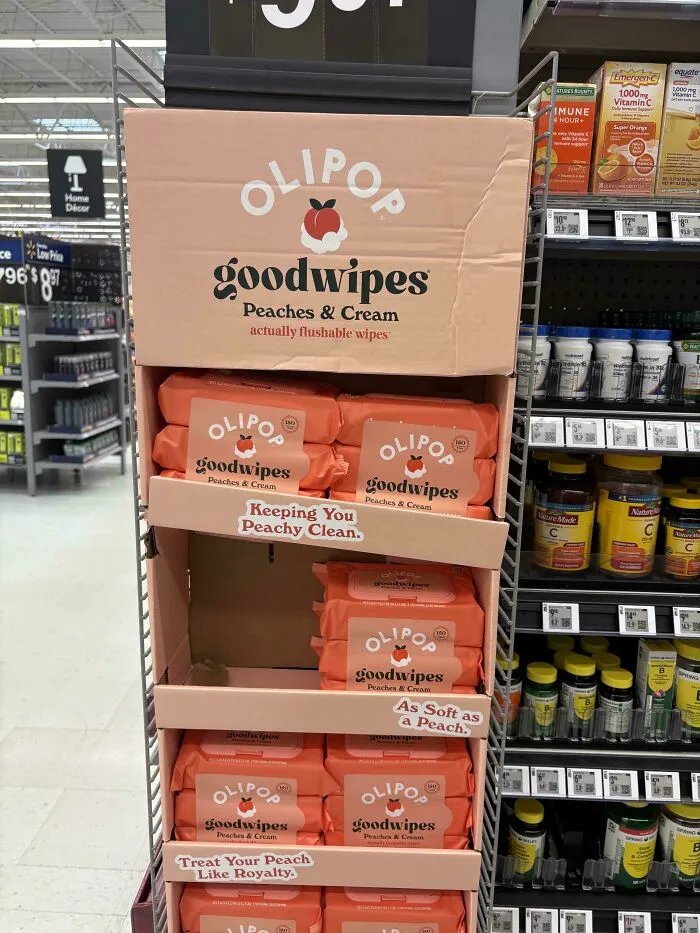 An OLIPOP Goodwipes display in a store aisle, illustrating product marketing and consumerism.