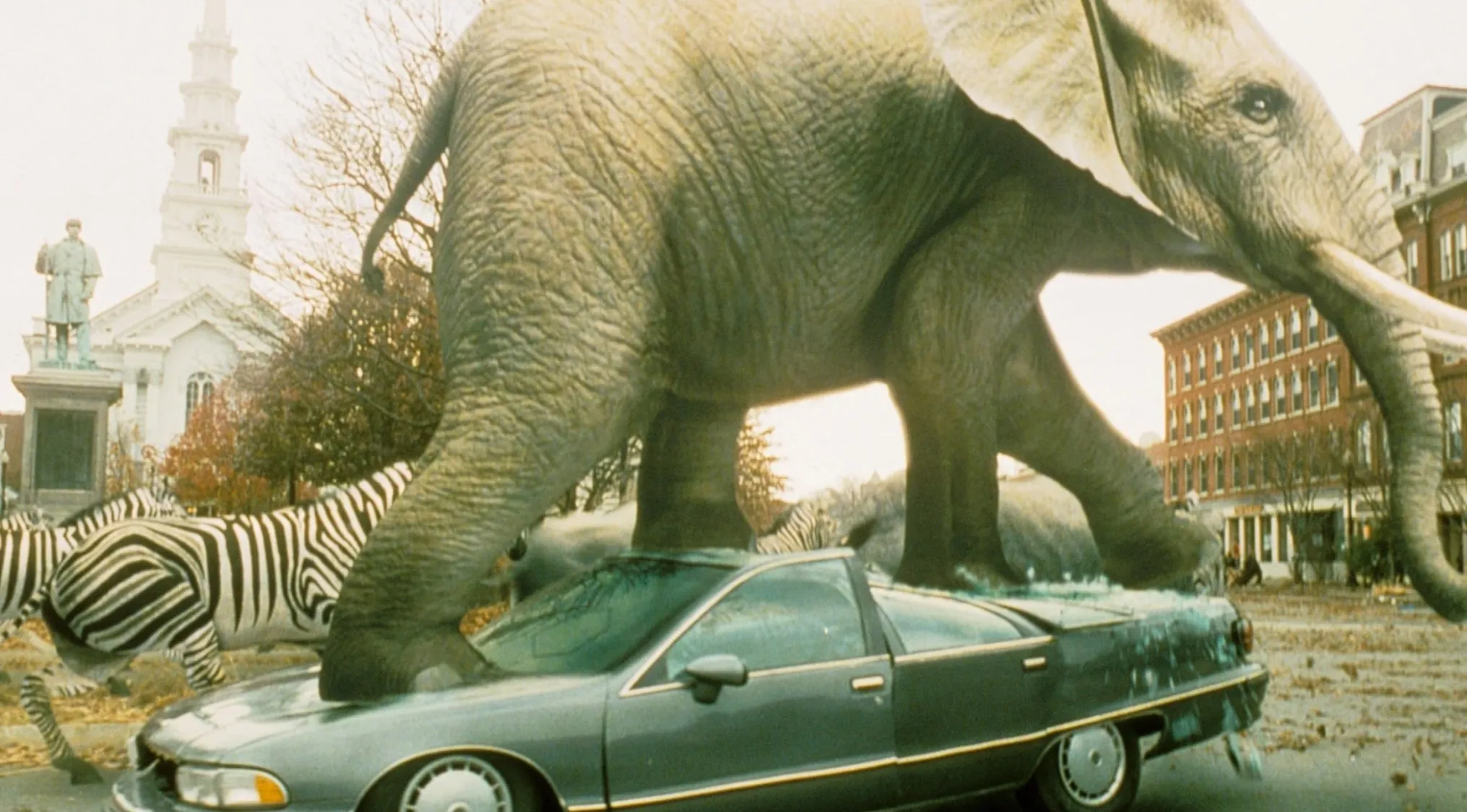 Scene from a 90s film showing jungle dangers with an elephant crushing a car and zebras in a city setting.
