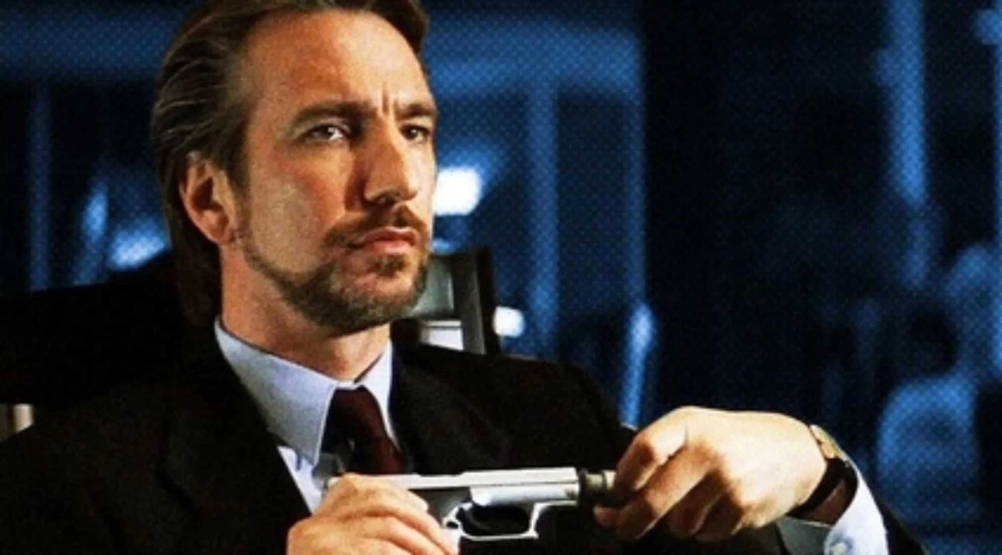 '80s and '90s villain in a suit calmly handling a handgun during a tense Christmas-time skyscraper crisis.