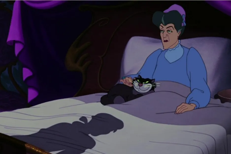 Strict authority figure from Cinderella lying in bed with a black cat, showing obsession and cruelty in a dimly lit room.