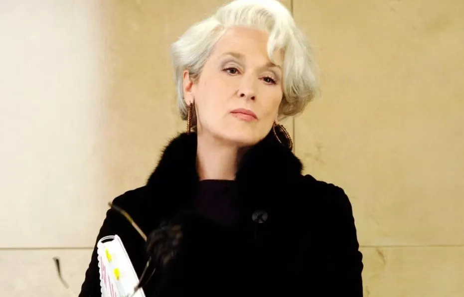 Miranda Priestly from The Devil Wears Prada with white hair and black fur coat as a fictional boss figure.