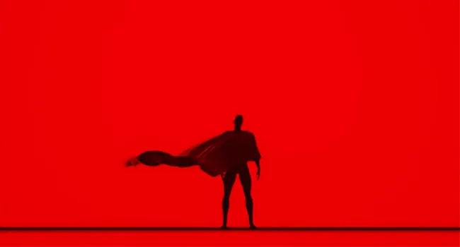 Silhouette of a person with a flowing cape against a red background, symbolizing soul-matching job superpowers.