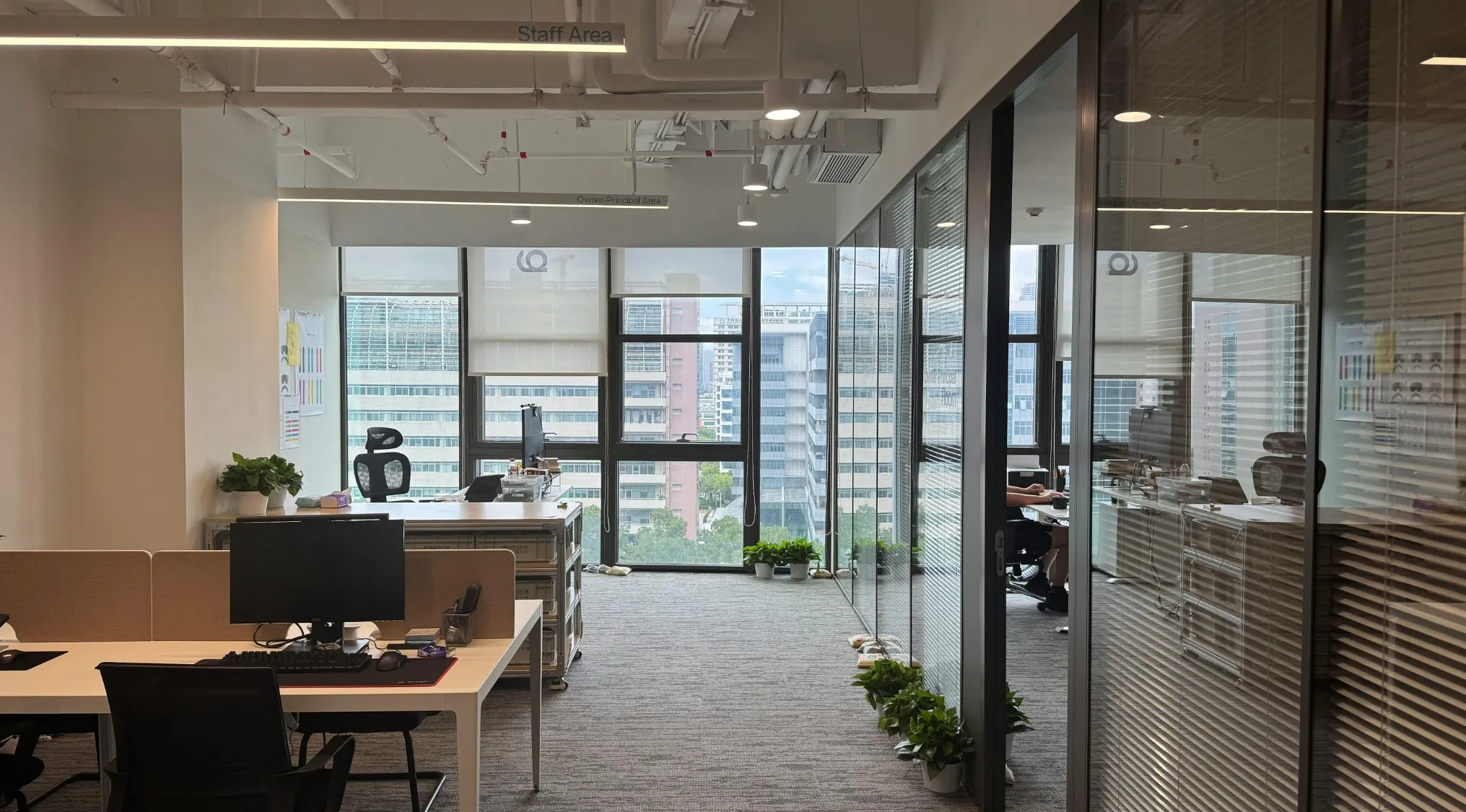 Modern office workspace with desks and glass walls, representing workplace mockumentaries in TV shows.